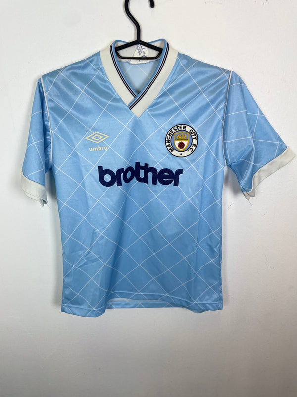 Vintage Manchester City home football shirt from 1987-89 in sky blue, kids sizing, mint condition, hand graded in Norway