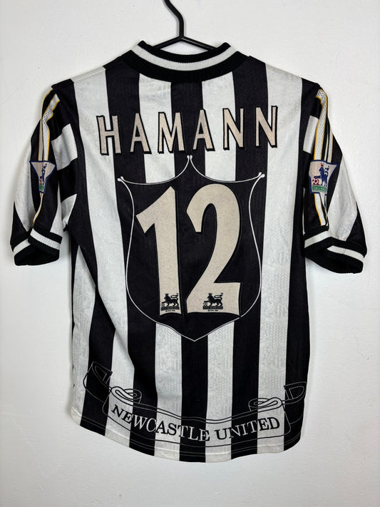Front view of the retro Newcastle 98/99 kids home shirt showing the black and white stripes, shown in full front detail
