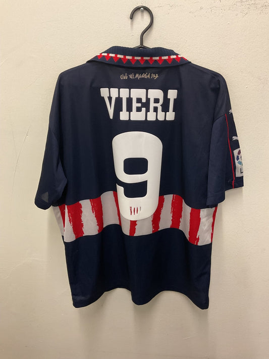 Front view of the retro Atletico Madrid 97/98 away shirt showing the club crest and sponsor, shown in full front detail