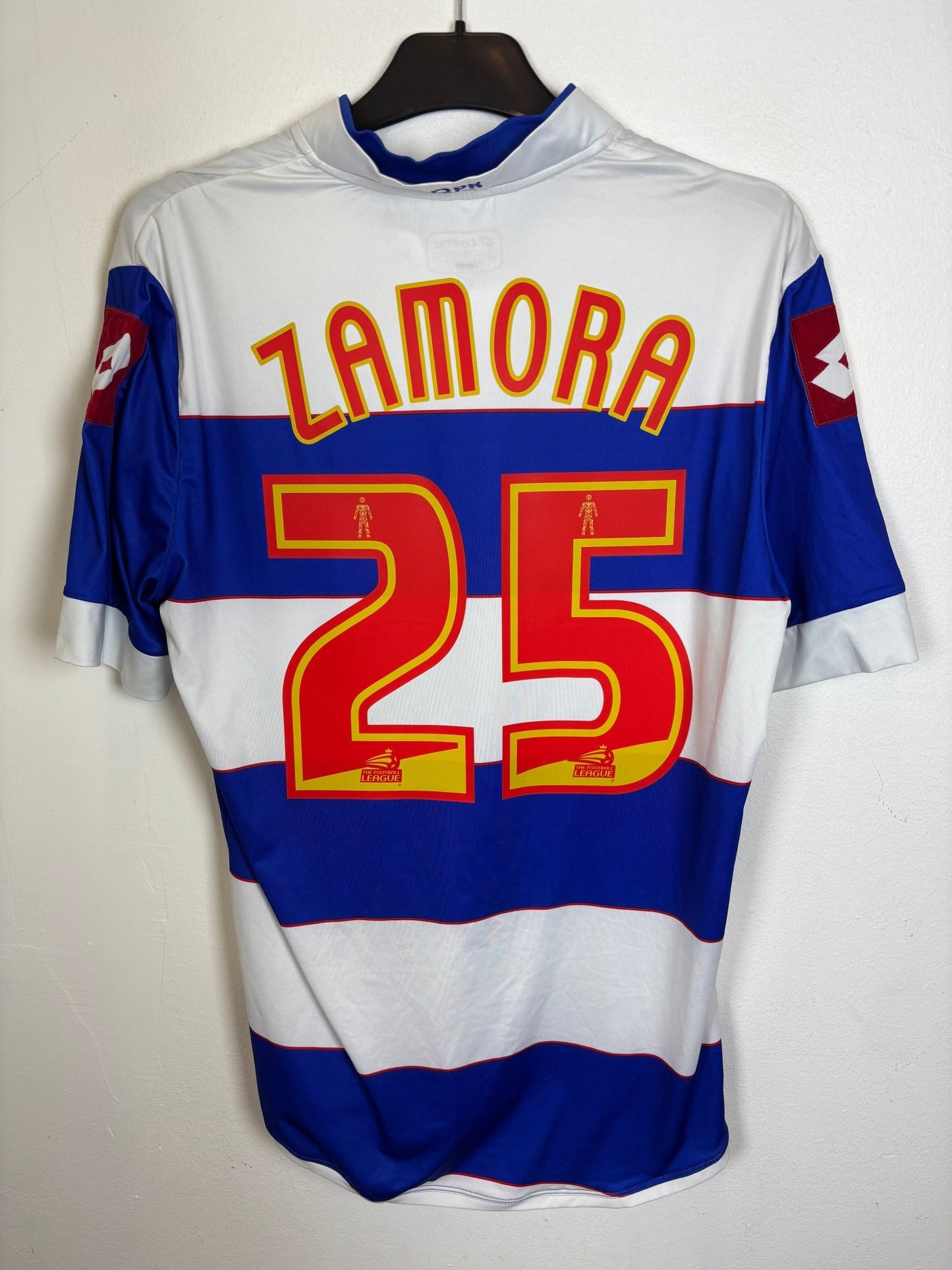 Front view of the QPR 13/14 home shirt showing the hooped club crest and sponsor print, photographed at our Stavanger store