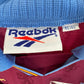 Close-up of the Aston Villa club crest on the original 95/97 claret and blue home shirt, shown in close detail