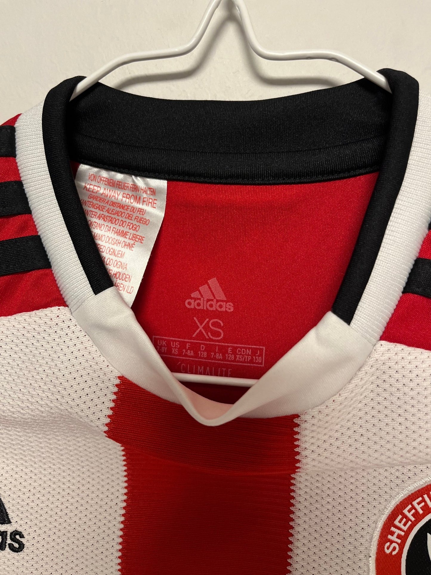 Back of the Sheffield United 2019/20 striped youth home shirt without nameset, photographed against a plain background