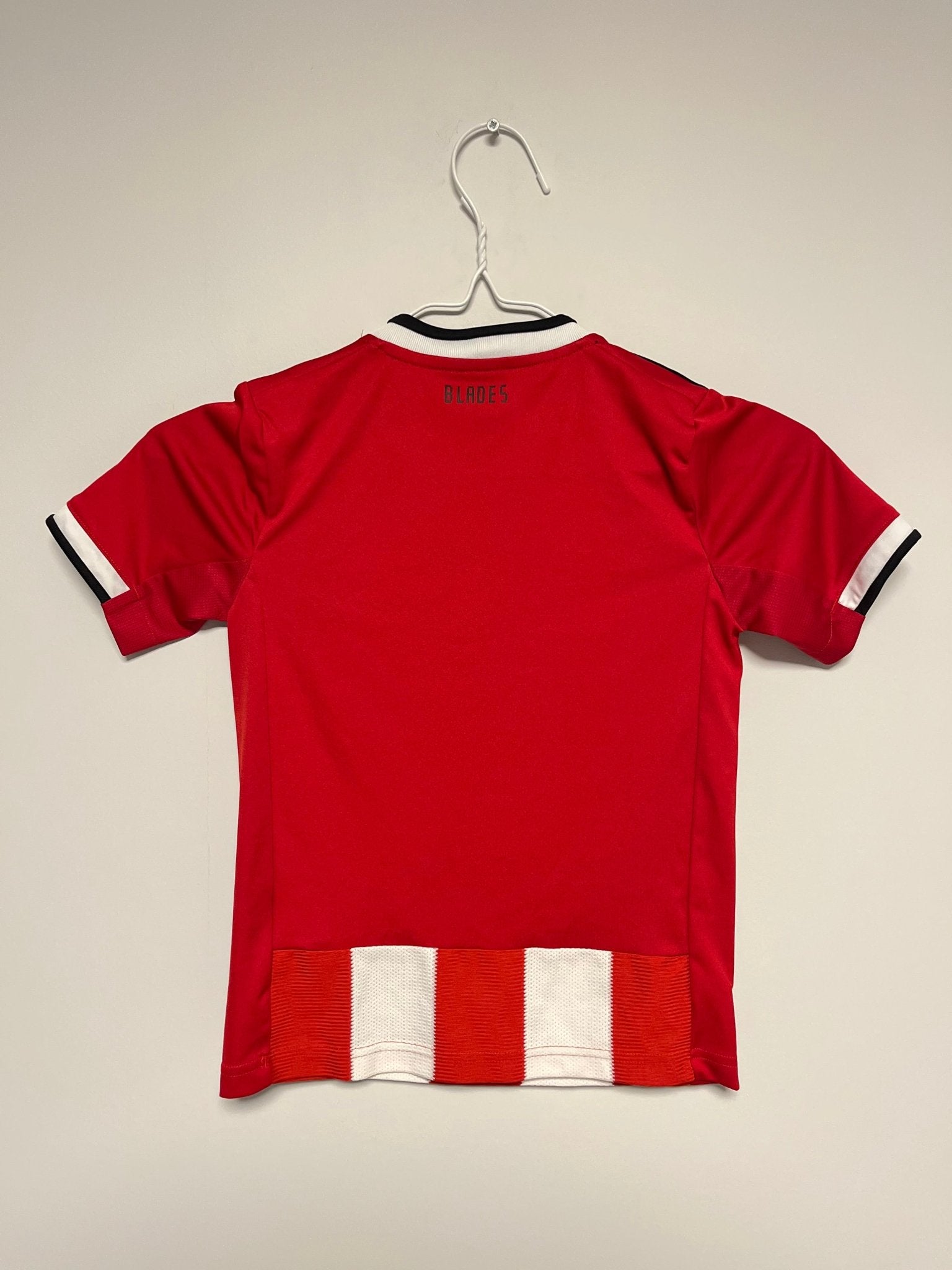 Front view of the Sheffield United 19/20 kids home shirt showing the Blades badge and sponsor, shown in full front detail