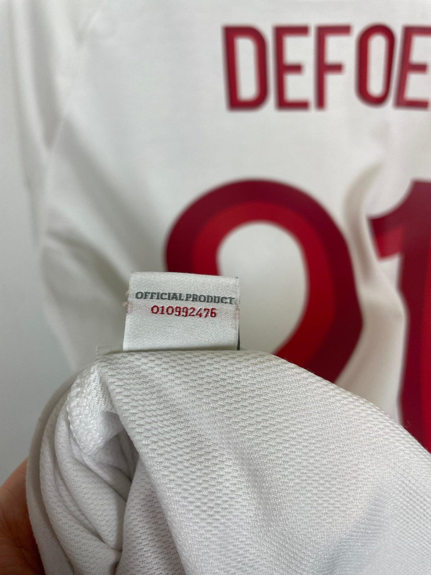 Close-up of the England national team crest on the 2012 white Umbro home shirt, photographed in detail for accurate grading