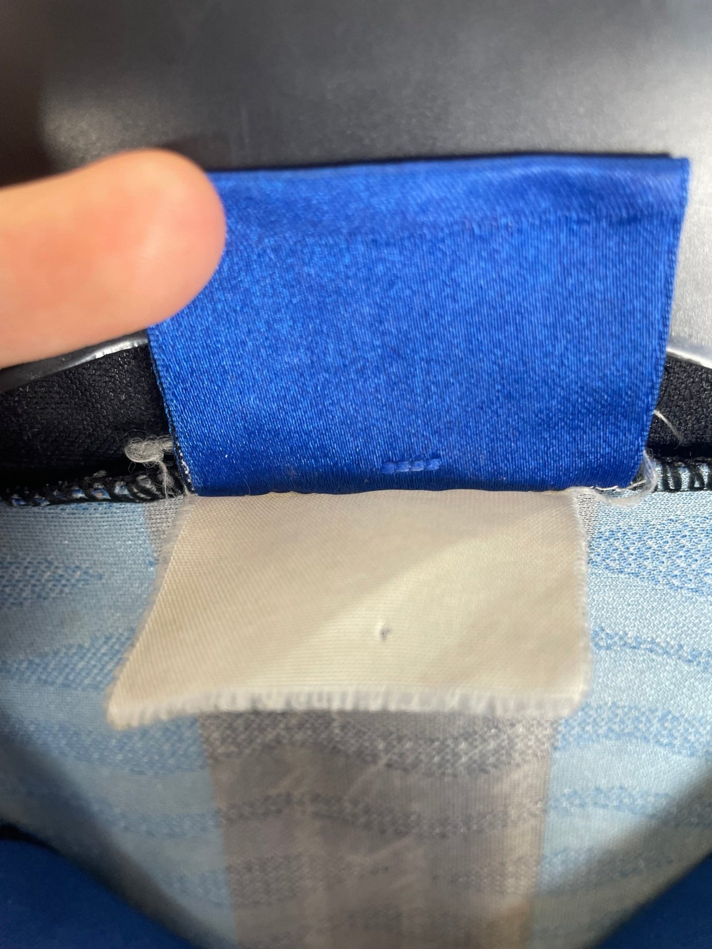 Close-up of the Inter Milan club crest on the original 96/97 black and blue striped shirt, shown in close detail