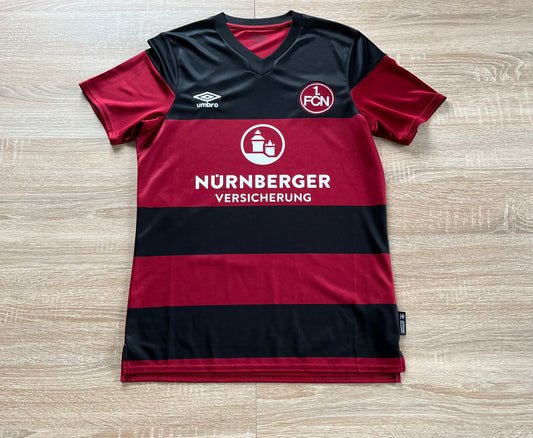 1. FC Nürnberg Home Shirt from 2020-2021: The iconic home jersey of 1. FC Nürnberg for the 2020-2021 season, featuring the club's emblem and a unique design that signifies the team's identity and passion for the sport.